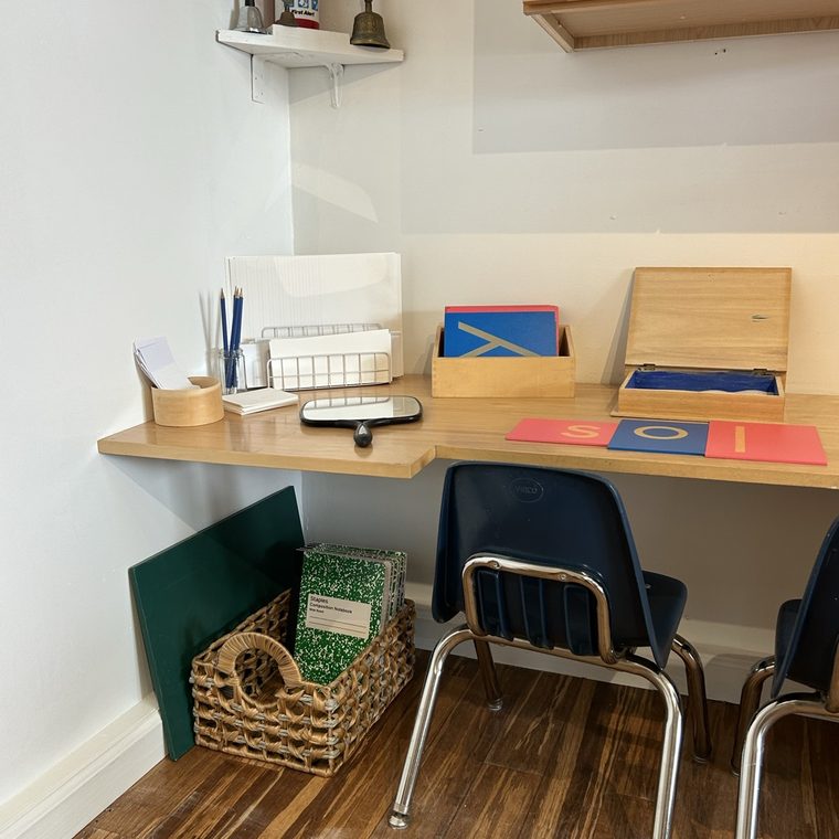A child's table and chairs set with learning materials
