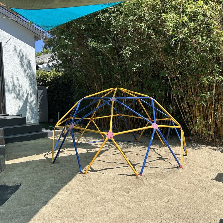 The backyard geodesic climbing dome in the sandy play yard